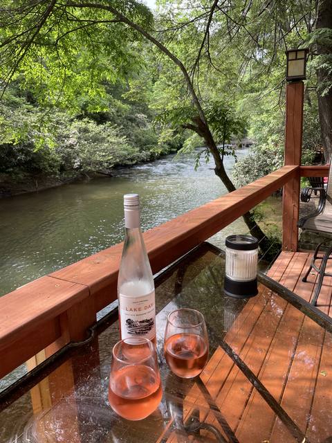 Rosé on the deck above the river