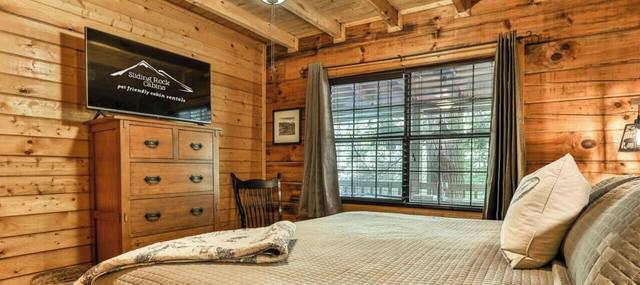 Bedroom with dresser and TV
